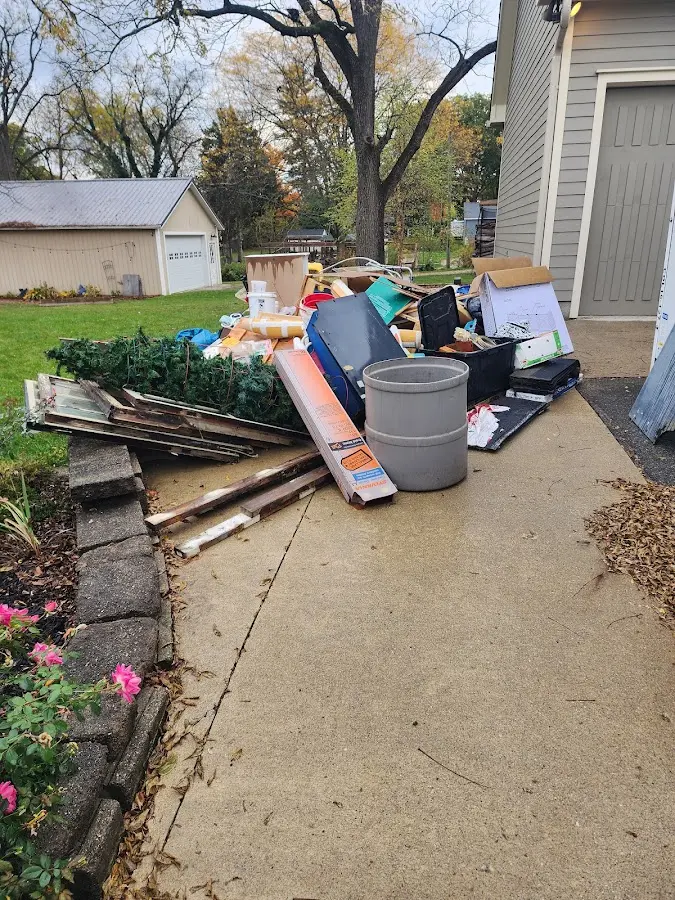 Dumpster being loaded with debris for Estate Cleanout Dumpster Rental in Redlands